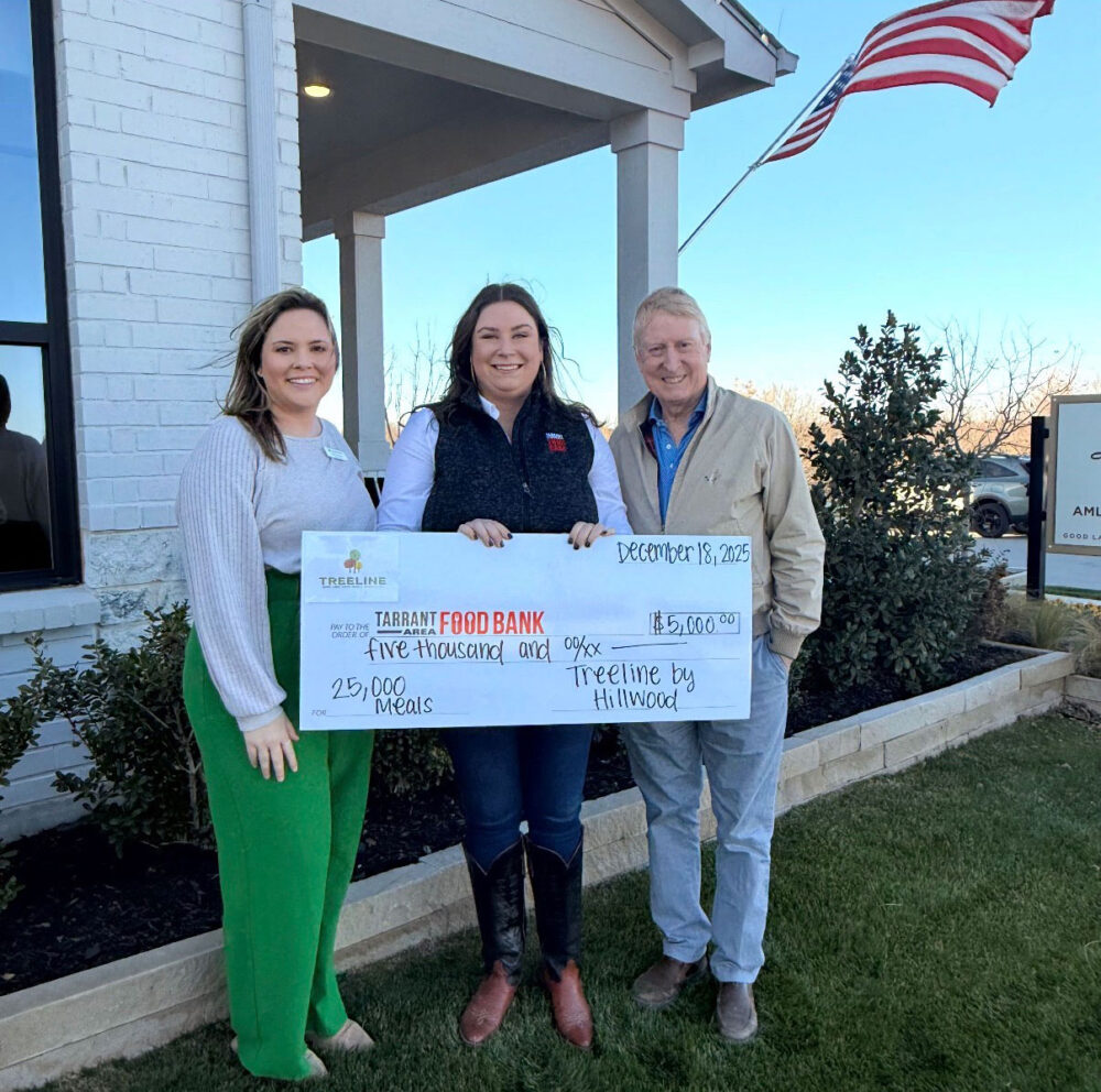 Three people with a large check addressed to the Tarrant Area Food Bank